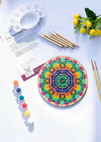 Complete Arttykase dot mandala art kit on light blue background - 8-inch round pre-marked board, 5 dotting tools, 6 acrylic paints, brushes and instruction guide