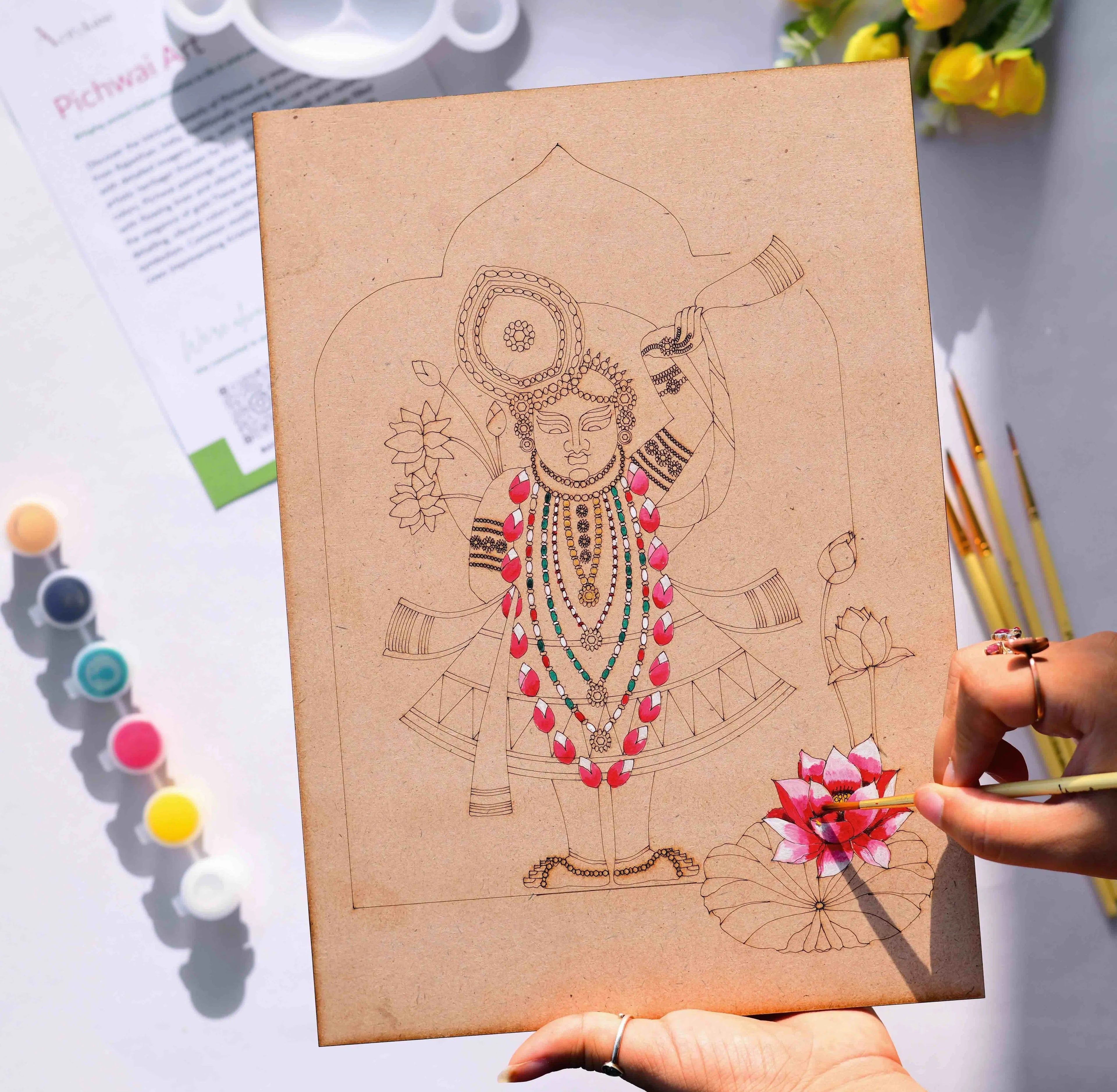 Person painting a Lord Krishna Pichwai devotional folk art design on an Arttykase pre-marked wooden board - sacred lotus motif Indian DIY art kit