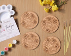 Madhubani bird mandala coaster painting kit — 4 pre-marked 3.5-inch MDF wooden coasters with Indian folk art bird designs, acrylic paints and brushes on a wooden surface