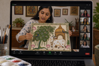 Arttykase Pichwai painting online workshop - Indian instructor showing completed Pichwai artwork to students on a Zoom video call with paints and palette in foreground