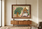 Finished Pichwai painting in an ornate wooden frame hanging on a living room wall above a wooden sideboard - Arttykase Indian folk art online workshop