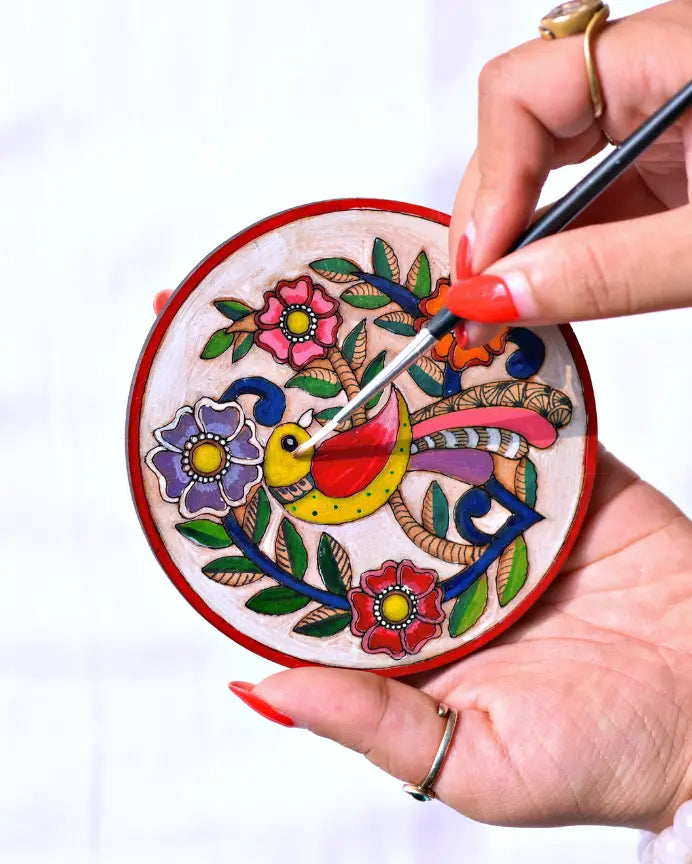 Practical Décor Kits collection - hand-painted Madhubani bird mandala coasters on a wooden surface — Arttykase Indian folk art DIY coaster painting kits